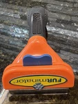Furminator Long Hair Deshedding Tool For Medium Dogs. Fixed Price $10.95.